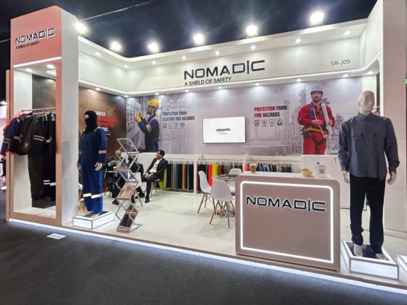 Nomadic safety workwear booth at Intersec Dubai featuring fire resistant uniforms, industrial protective clothing and mannequins display